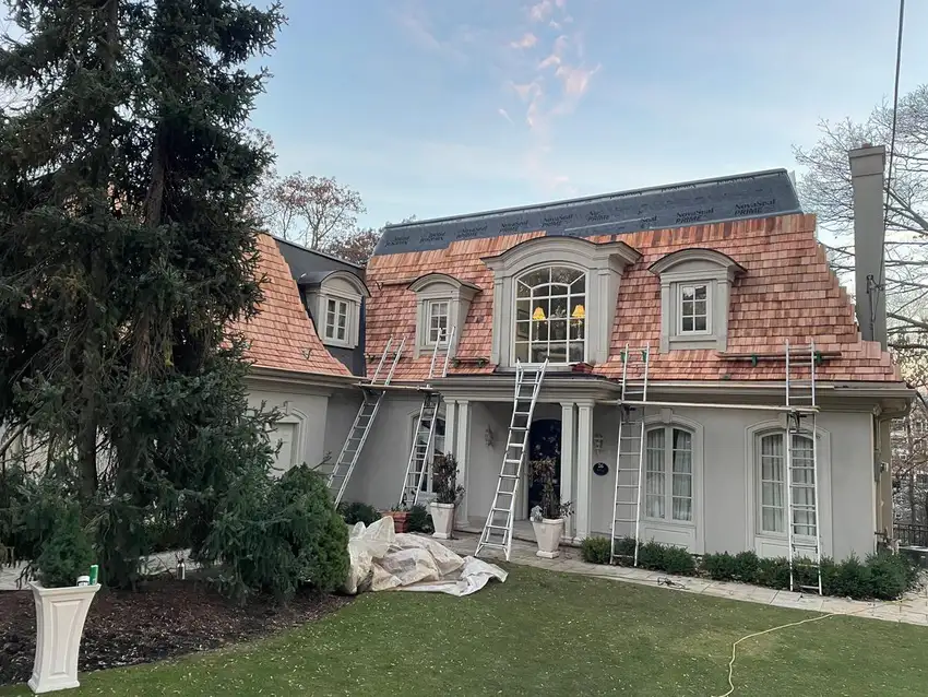 Roofing work in progress on a steep-pitch roof